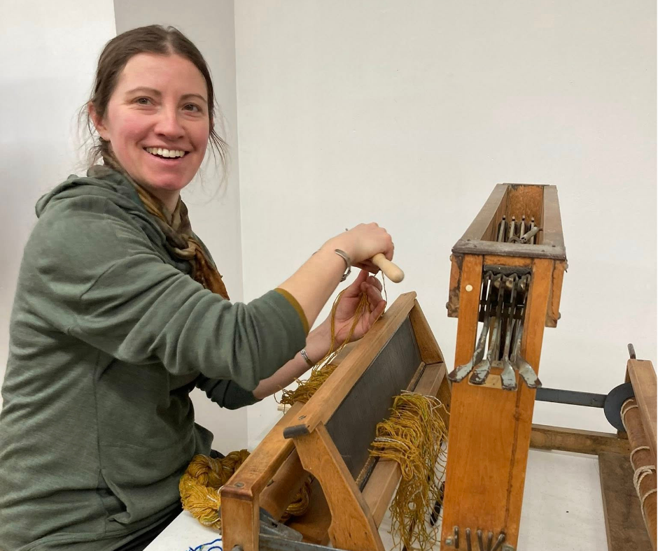 Guild member working at a loom