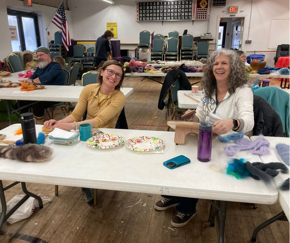 Guild members working together at a table during Open Studio